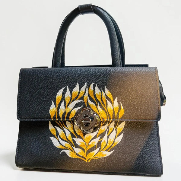 Hand painted black leather handbag with floral artwork from Ekeha bags collection