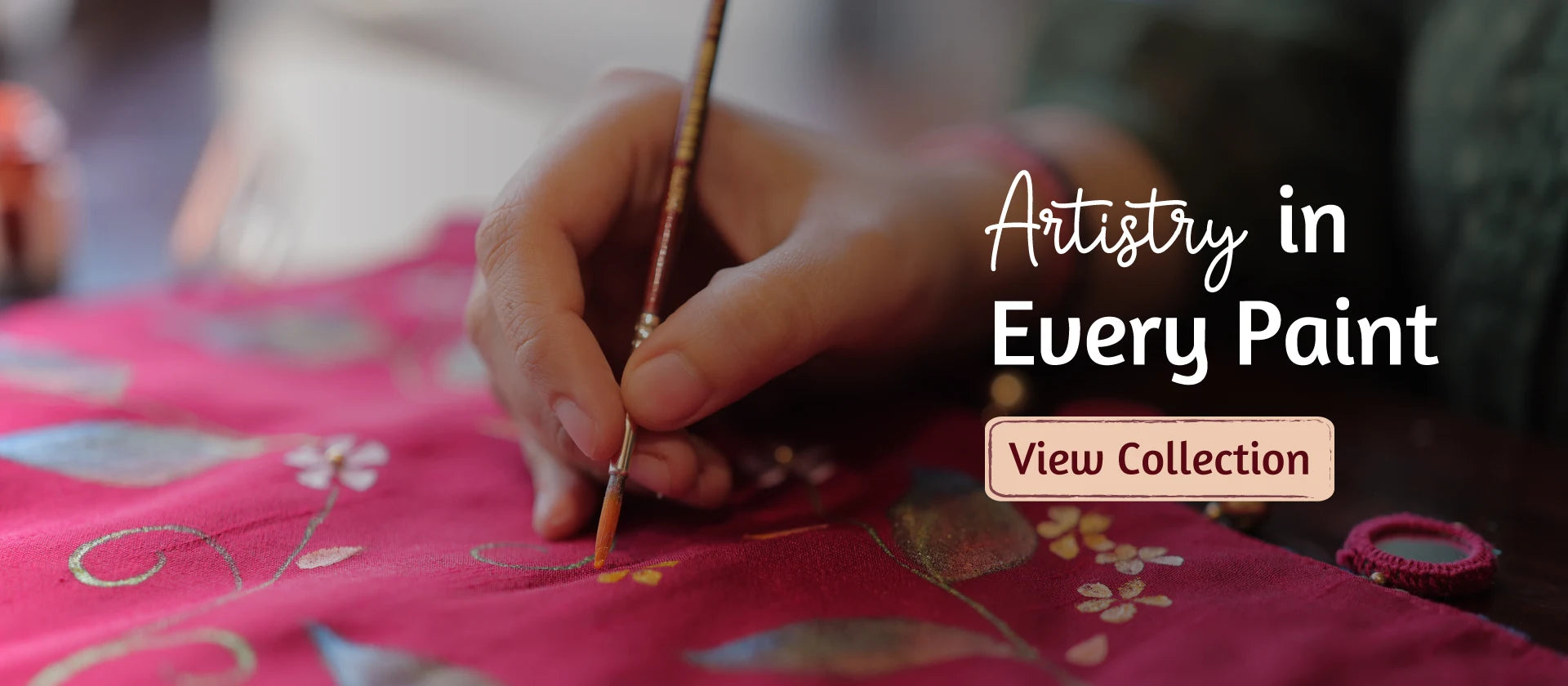 Artist hand painting floral design on a shawl for handmade shawl collection by Ekeha