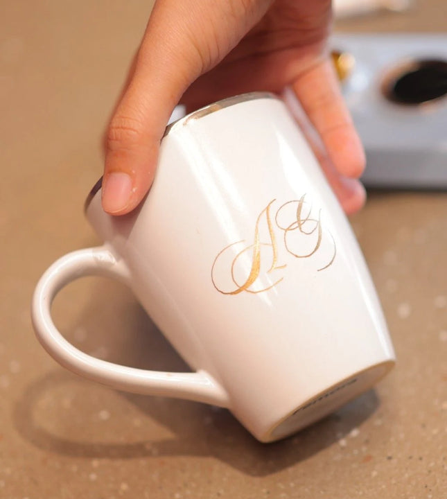 White ceramic mug with hand painted gold initials by Ekeha
