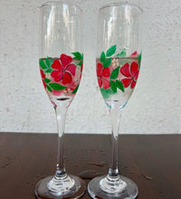 Set of 2 champagne glasses with hand-painted red floral design and green leaves on clear glass