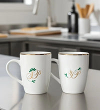 Set of 2 white ceramic mugs with gold rim and personalised initials JP and YP with green leaf design